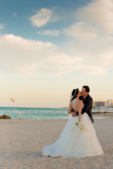 Bride and Groom Kiss on the Beach