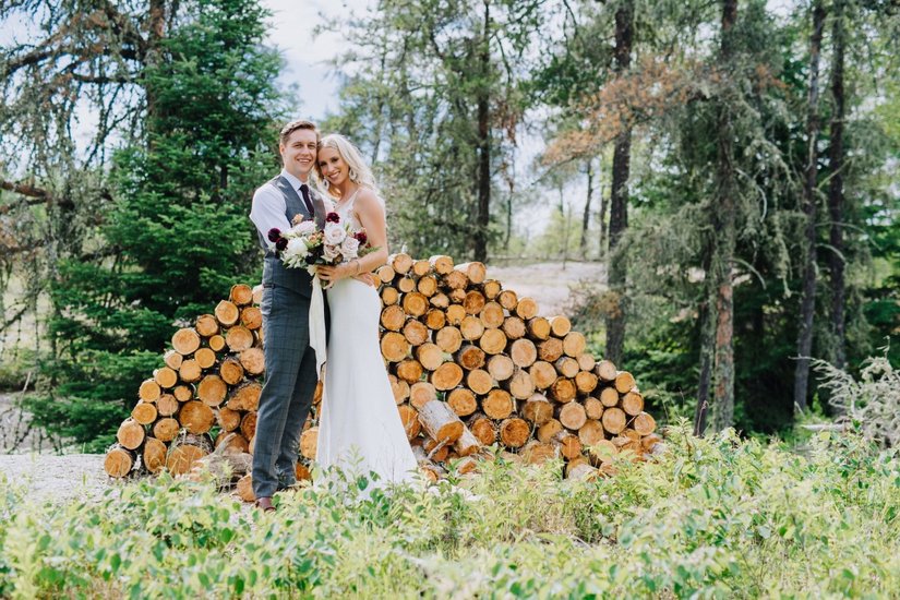 Krystyl and Keith in front of log wall 