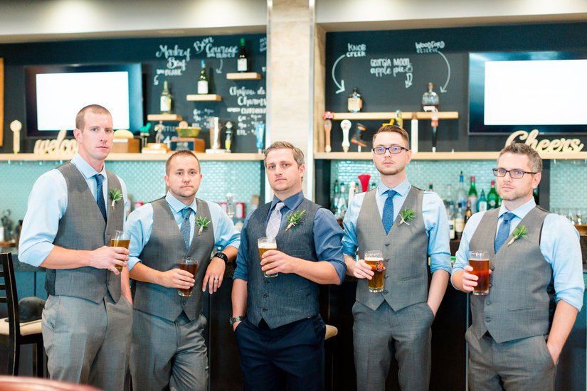 Groomsmen having beers before the ceremony