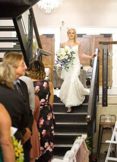 Bride walks down stairs in blue heels