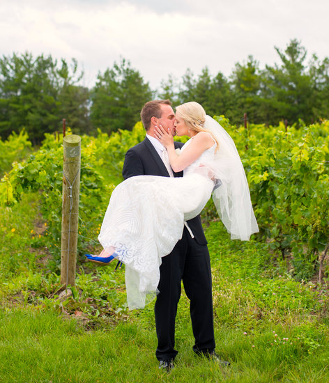 Bride & Groom kiss in the vineyard