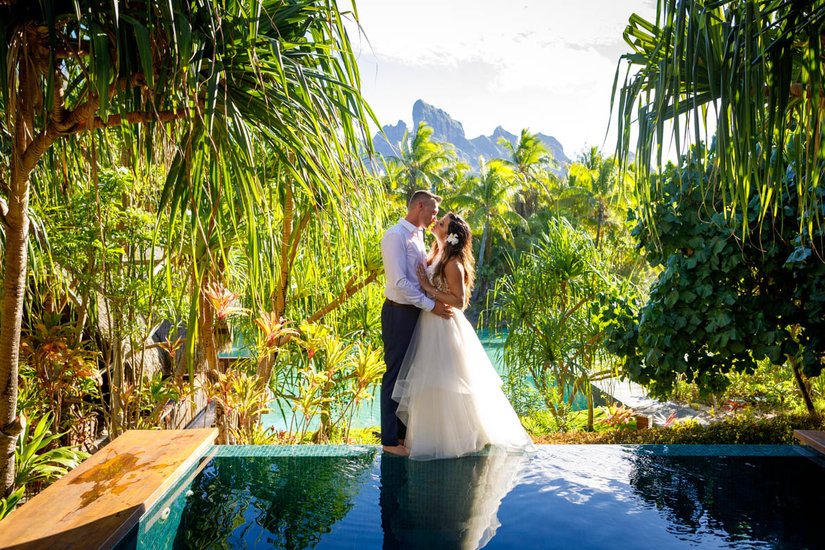 Bride and groom kissing in the gardens at the spa at the Four Seasons Bora Bora