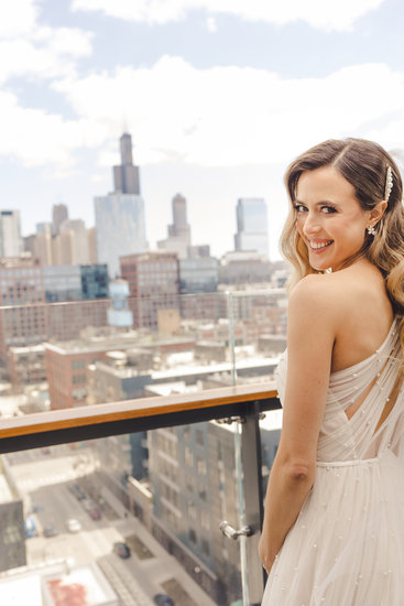 Bride looks at camera over her shoulder with Chicago, IL in the background